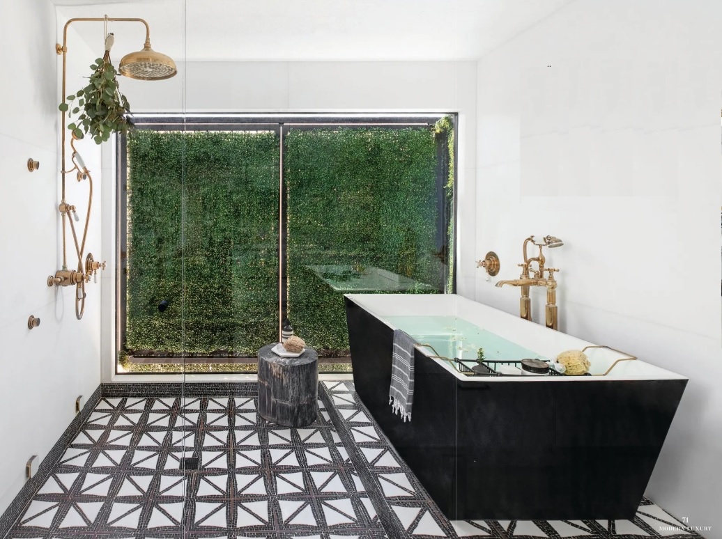 A stunning shower and free-standing tub are set against a verdant outdoor wall in the primary bathroom PHOTO BY JENNY SIEGWART