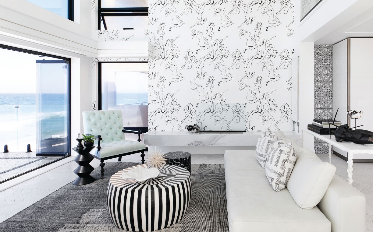 Artist Regina Yazdi created the living room’s custom pinup wallpaper, where furnishings by Minotti, Kelly Wearstler and Oly Studio are found. PHOTO BY JENNY SIEGWART