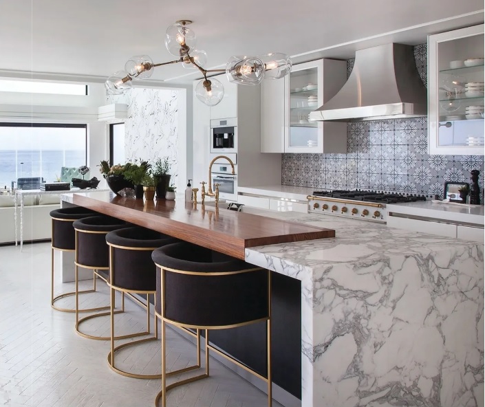  The kitchen includes bar stools by Restoration Hardware and luxury Miele appliances.  PHOTO BY GAIL OWENS