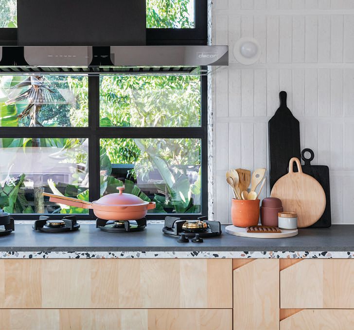 Terrazzo countertops from Concrete Collaborative and wall tiles from Clé Tile adorn the kitchen.  PHOTOGRAPHED BY JENNY SIEGWART