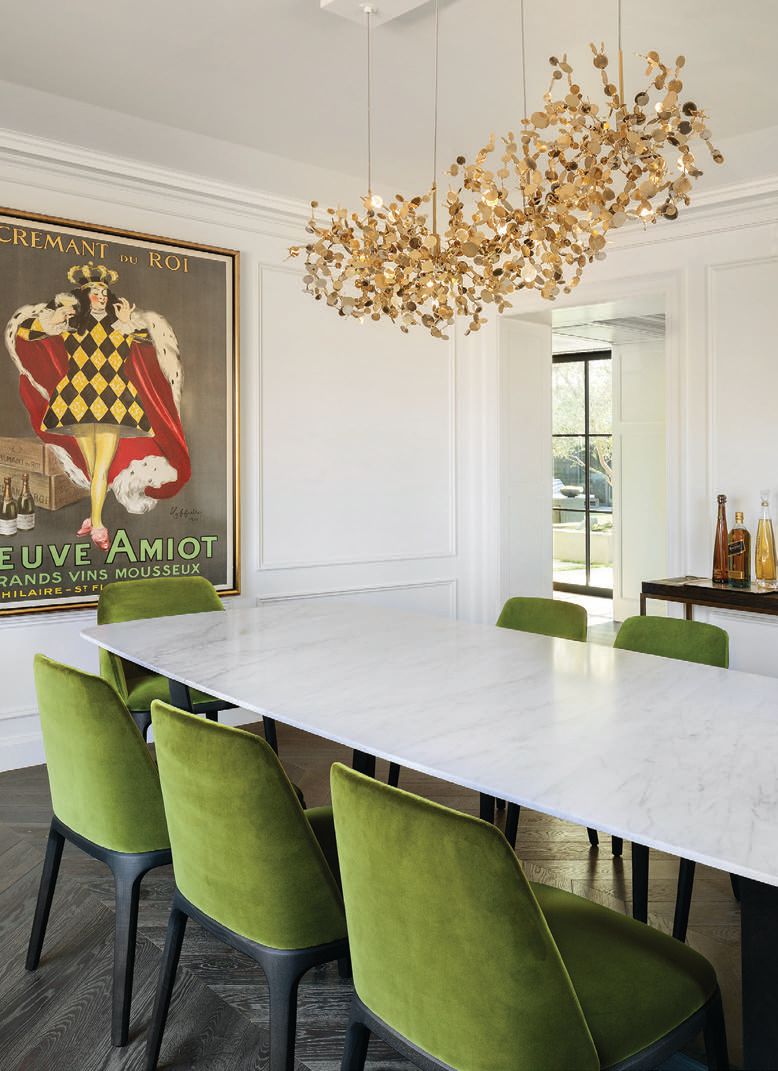 A Terzani Argent suspension light of gold discs hangs in the dining room PHOTO BY LAURA HULL PHOTOGRAPHY