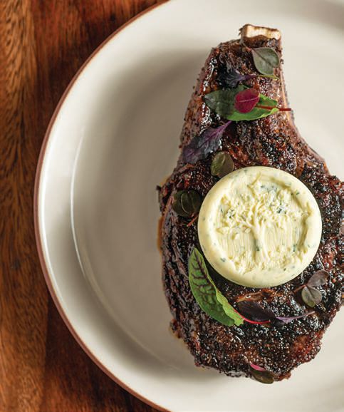 The Flannery beef ribeye topped with embossed buttered blue cheese at Ember & Rye. PHOTO BY DUSTIN BAILEY